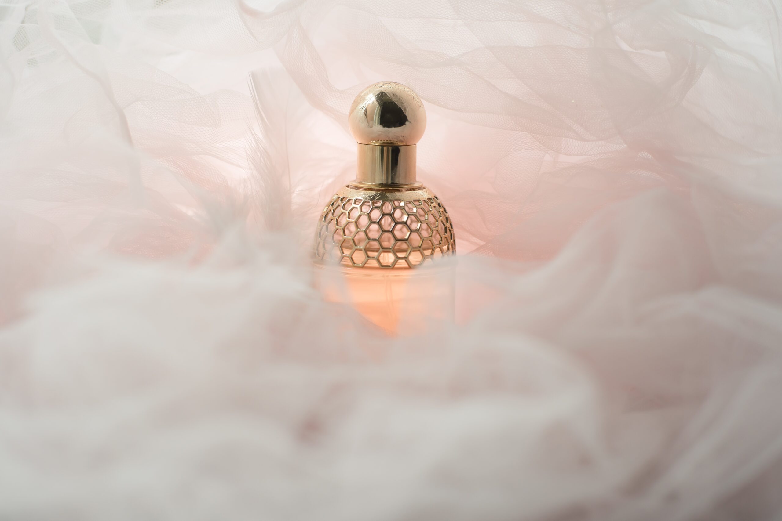 perfume-in-gold-bottle-and-pink-soft-background-2024-12-07-05-06-24-utc